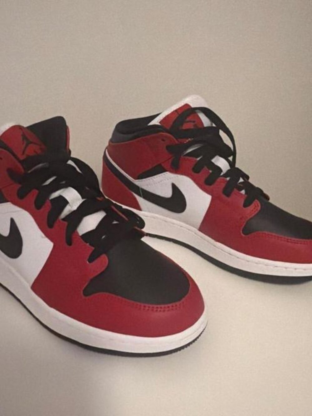 Jordan 1 Mid red, black, and white sneakers